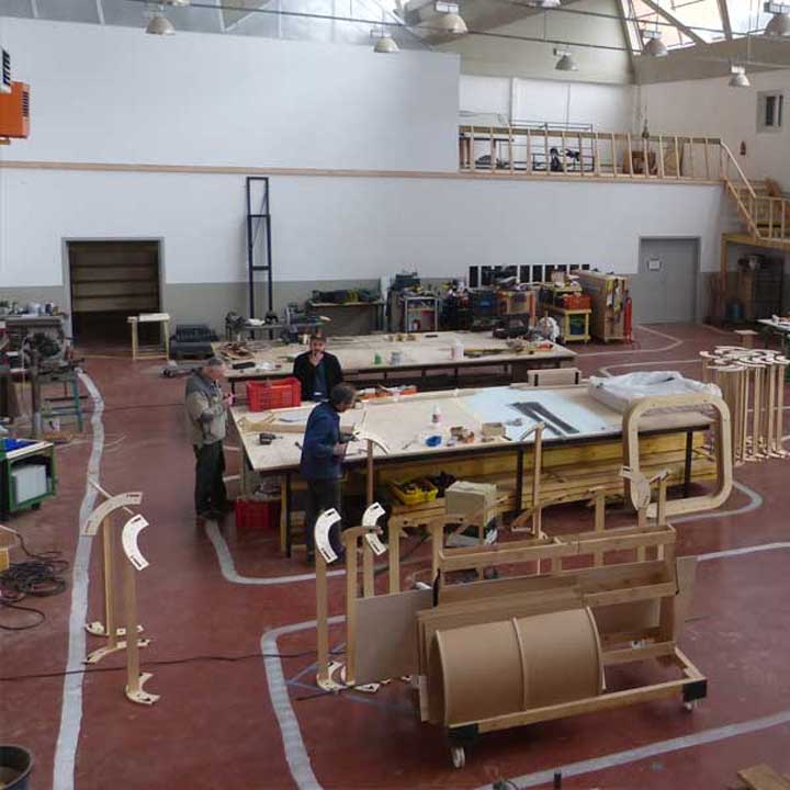 Trois artisans travaillant sur une grande table